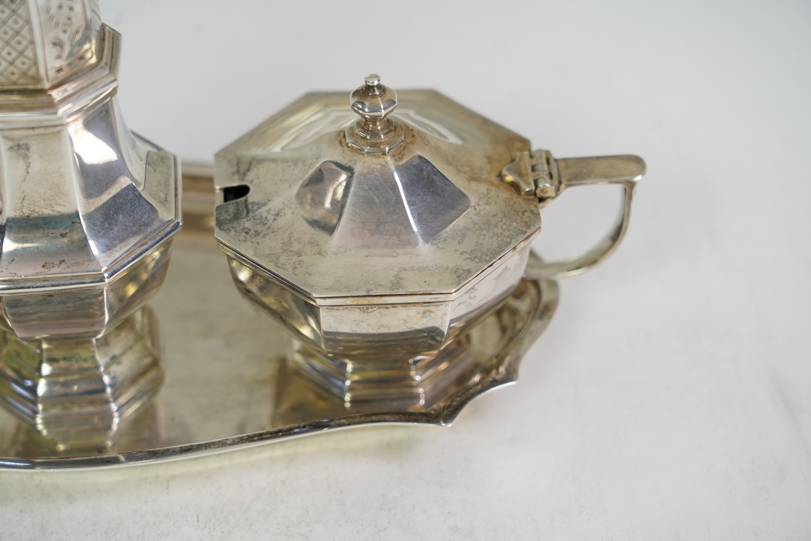 An Elizabeth II Asprey & Co silver three piece condiment set on stand